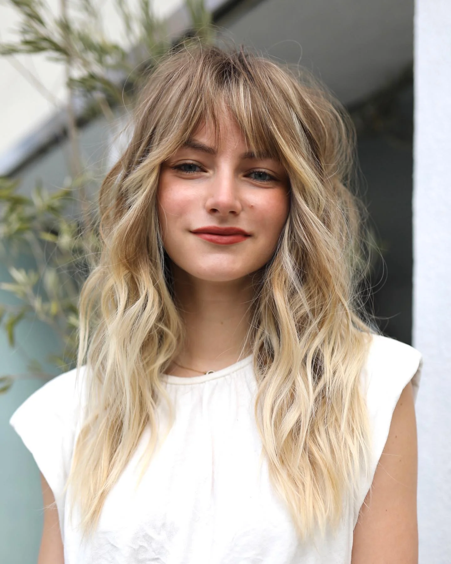 airy summer haircuts with bangs 2026 Beachy Layered Waves With Curtain Fringe