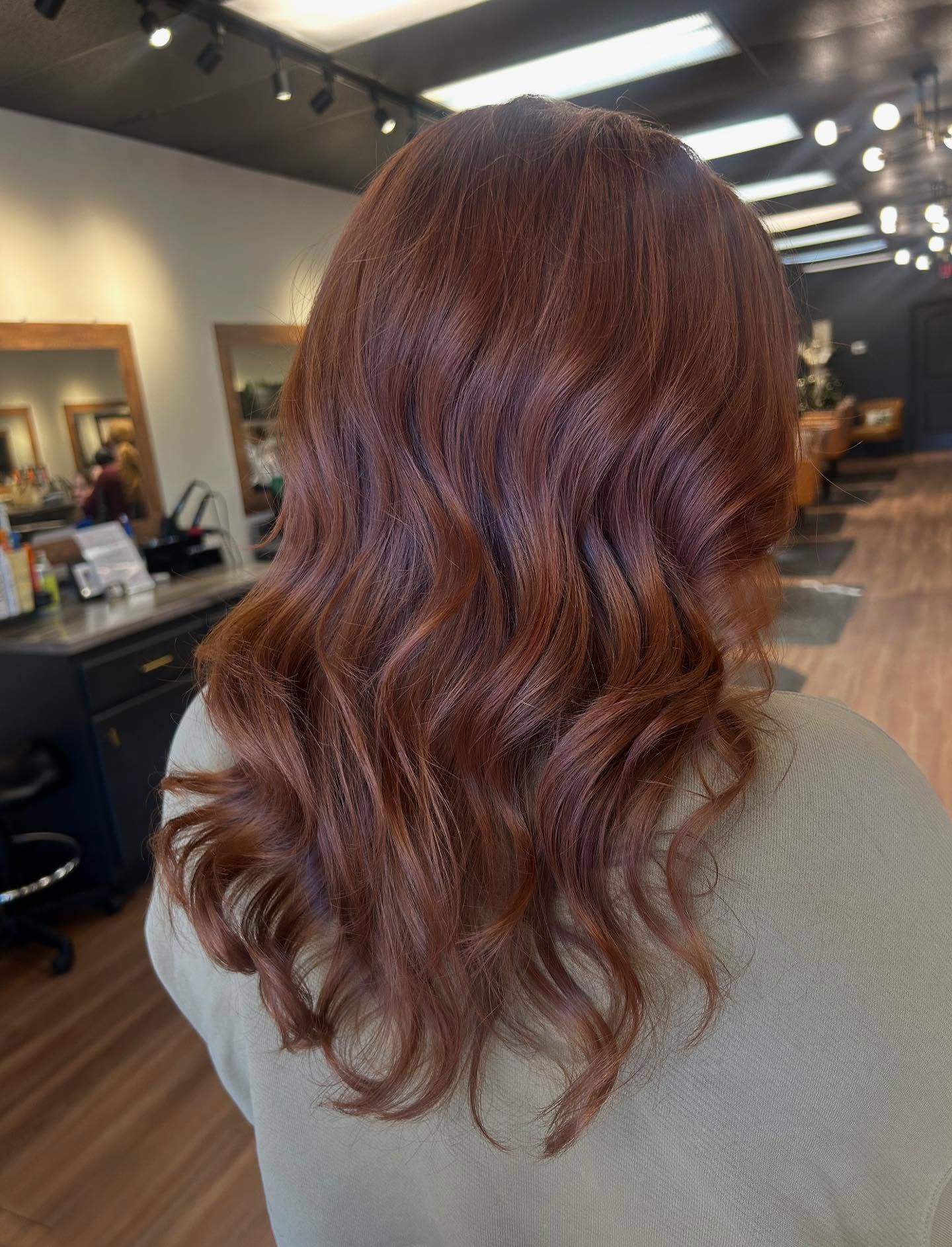 spicy summer auburn hair color 2026 Velvety Auburn Curls With Deep Reflective Shine