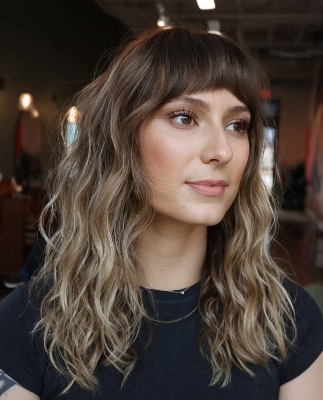 airy-summer-haircuts-with-bangs-2026 Textured Medium Waves With Wispy Fringe