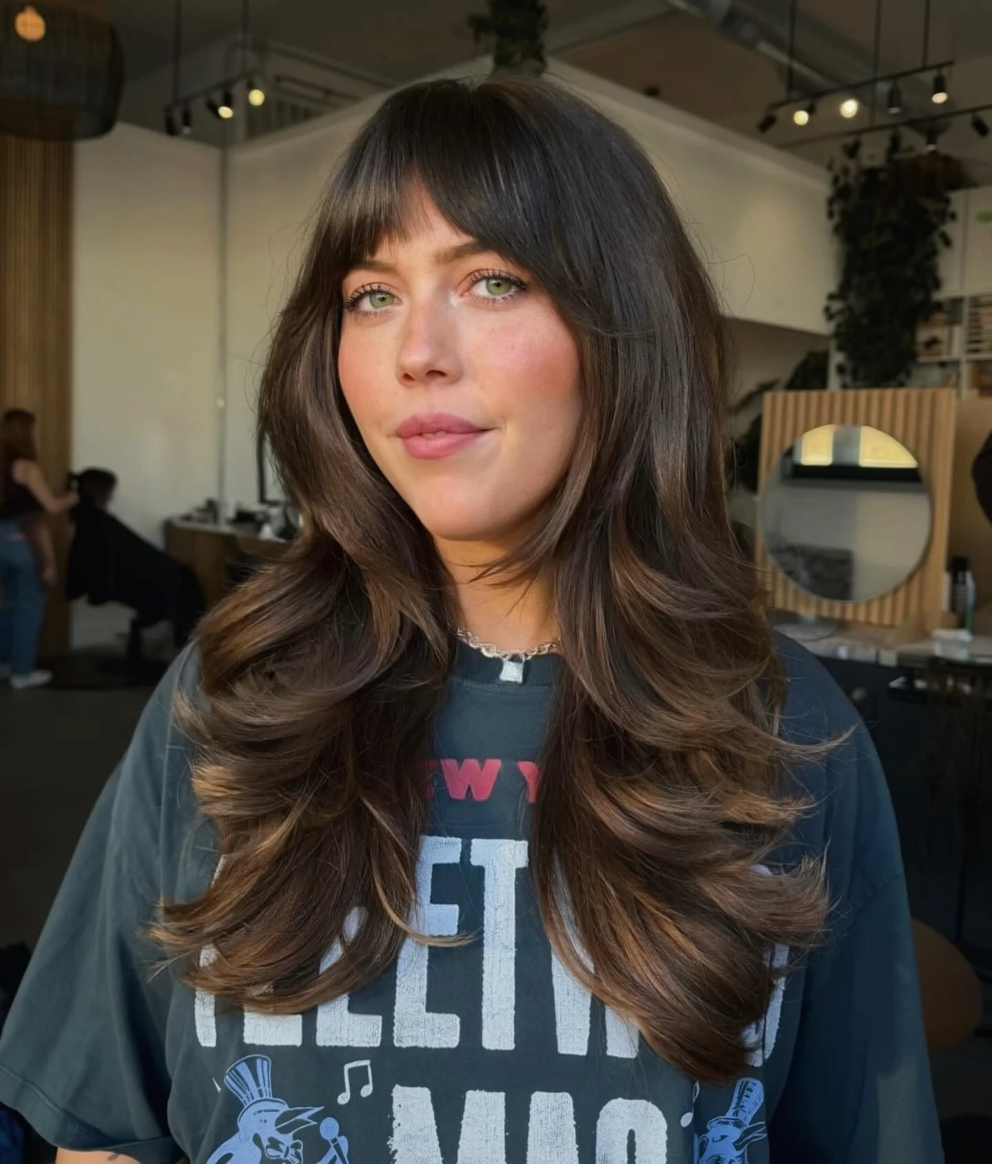 airy summer haircuts with bangs 2026 Glossy Medium Layers With Curtain Bangs
