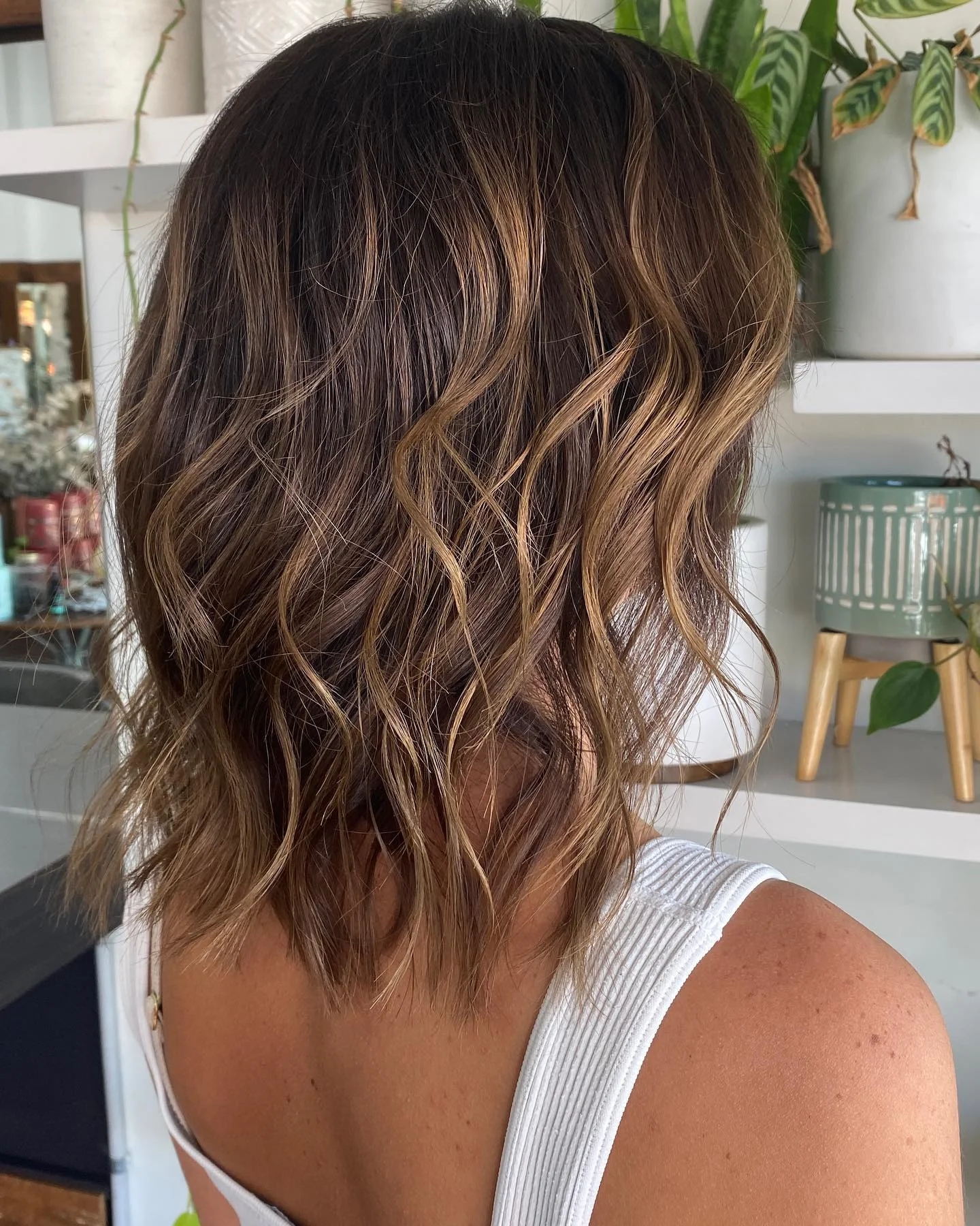 beachy summer hair color for tan skin 2026 Textured Brunette Lob With Golden Accent Strands