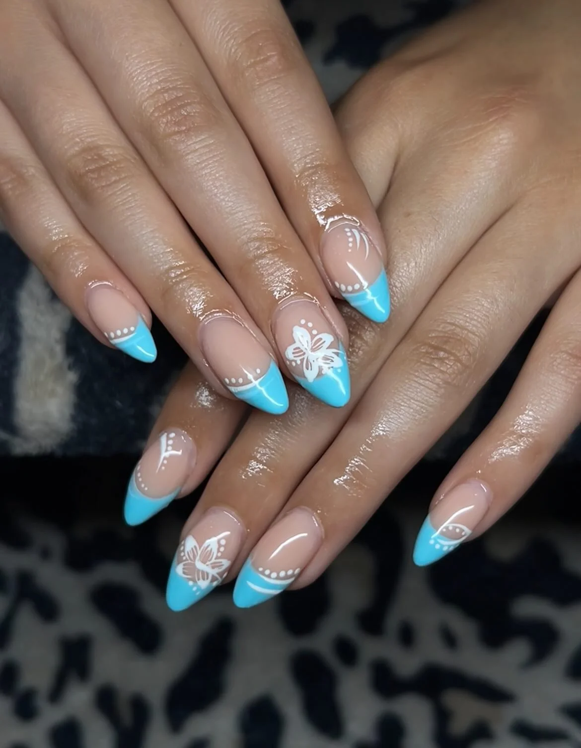 light blue summer nails 2026 Glossy Turquoise French Tips With Delicate Hibiscus Art