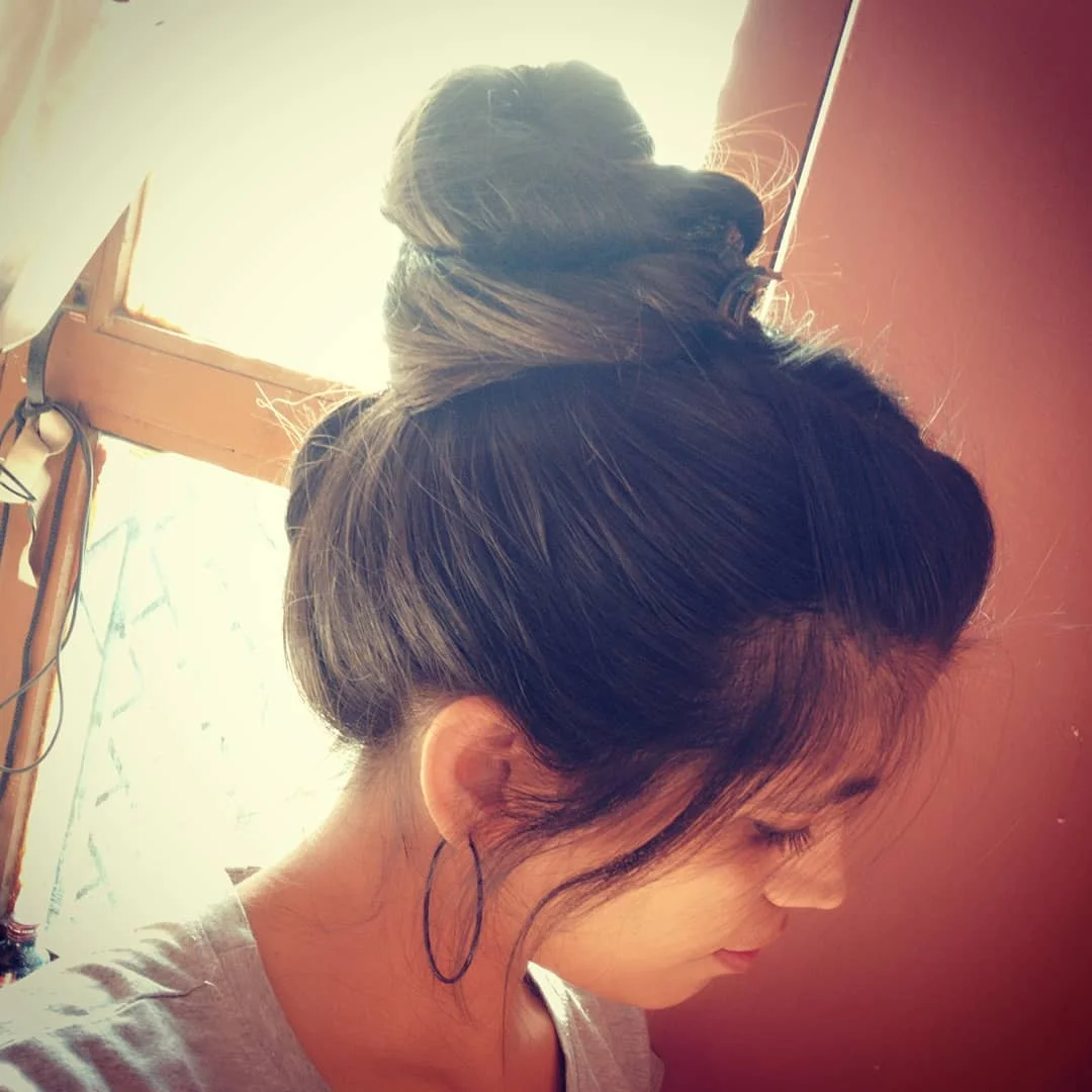 minimal summer easy hairstyle 2026 Undone Bun With Soft Face-Framing Pieces