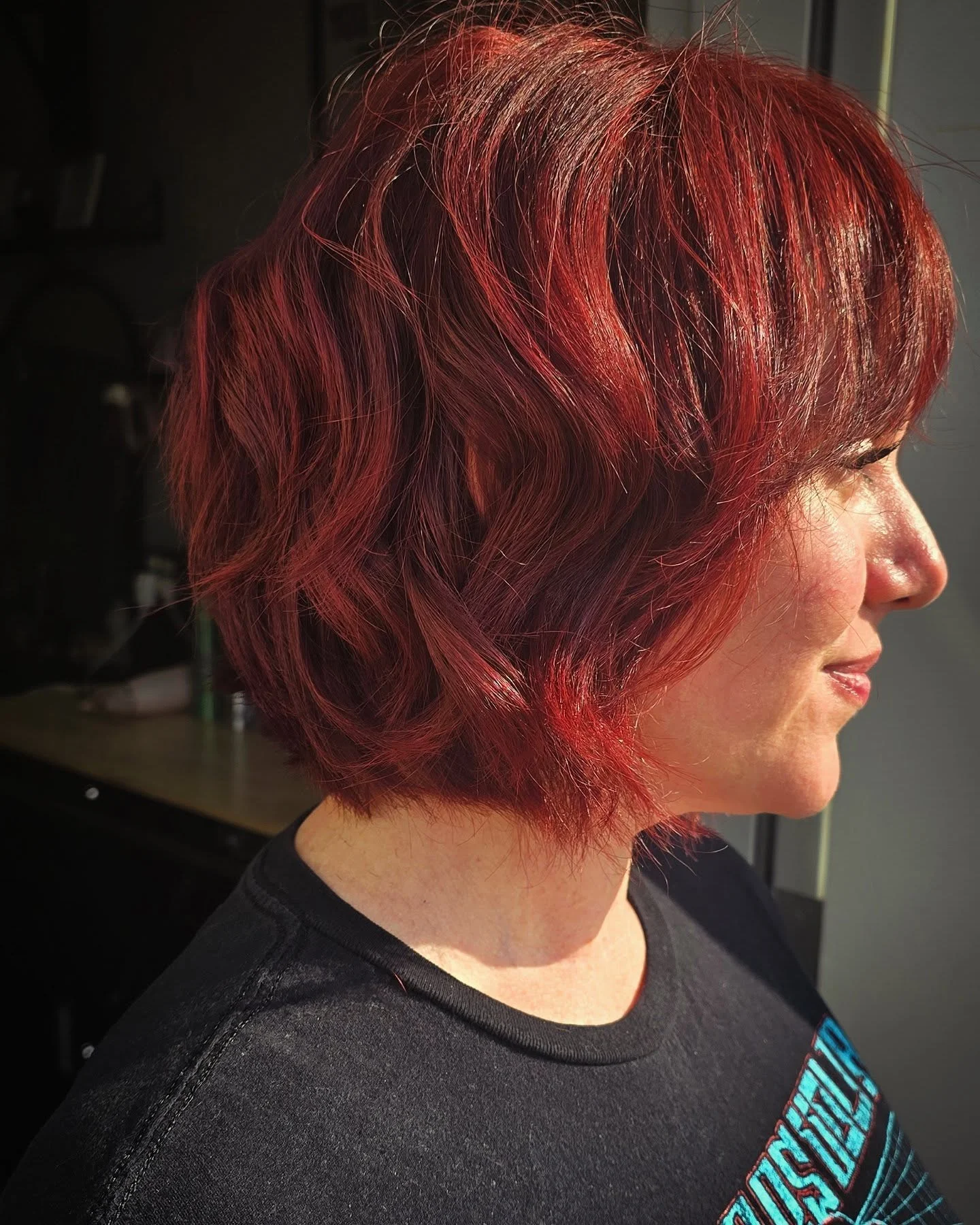 sophisticated summer haircuts for women over 40 2026 Glossy Red Layered Bob With Volume