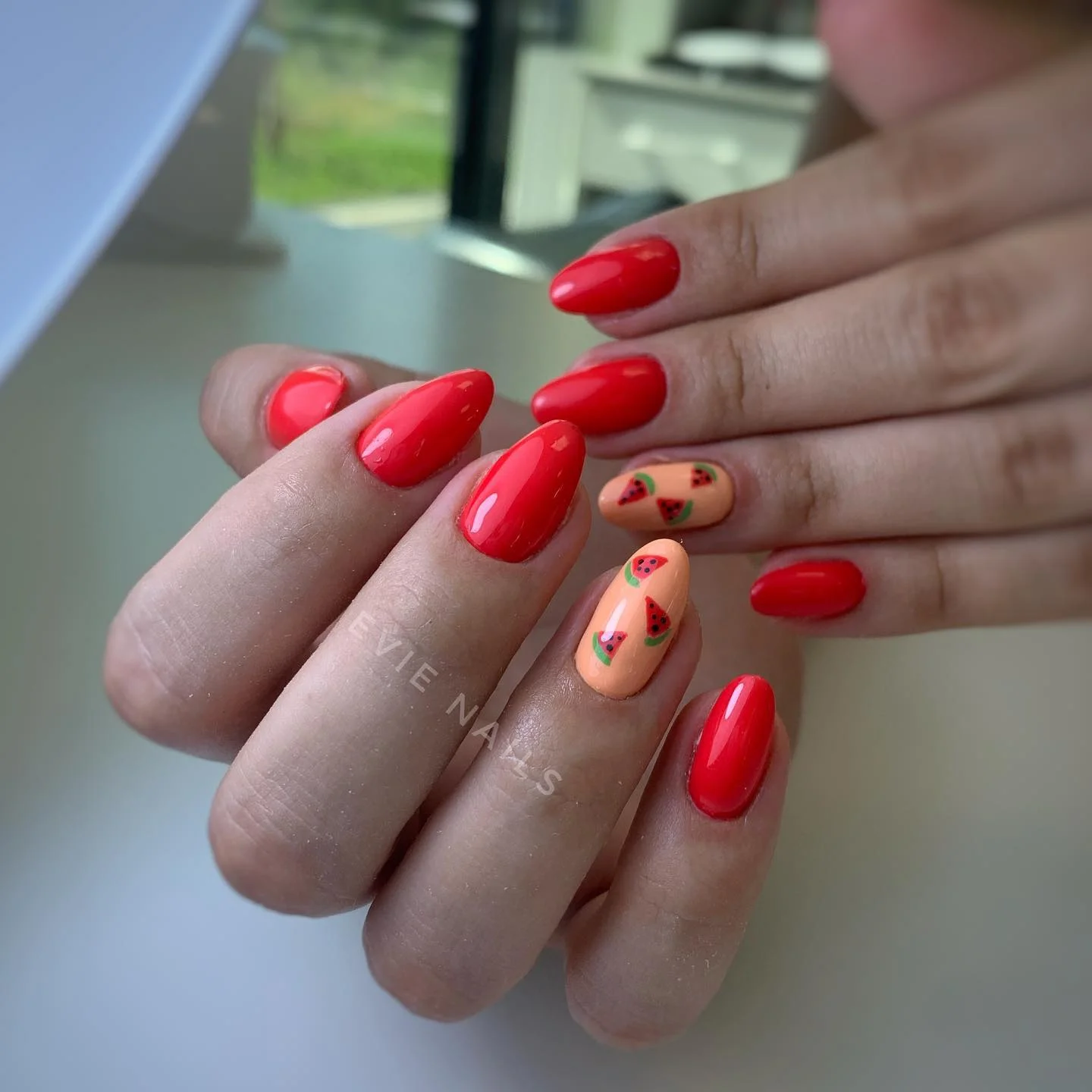 summer nails watermelon 2026 Glossy Red Almond Watermelon Nails With Peachy Accents