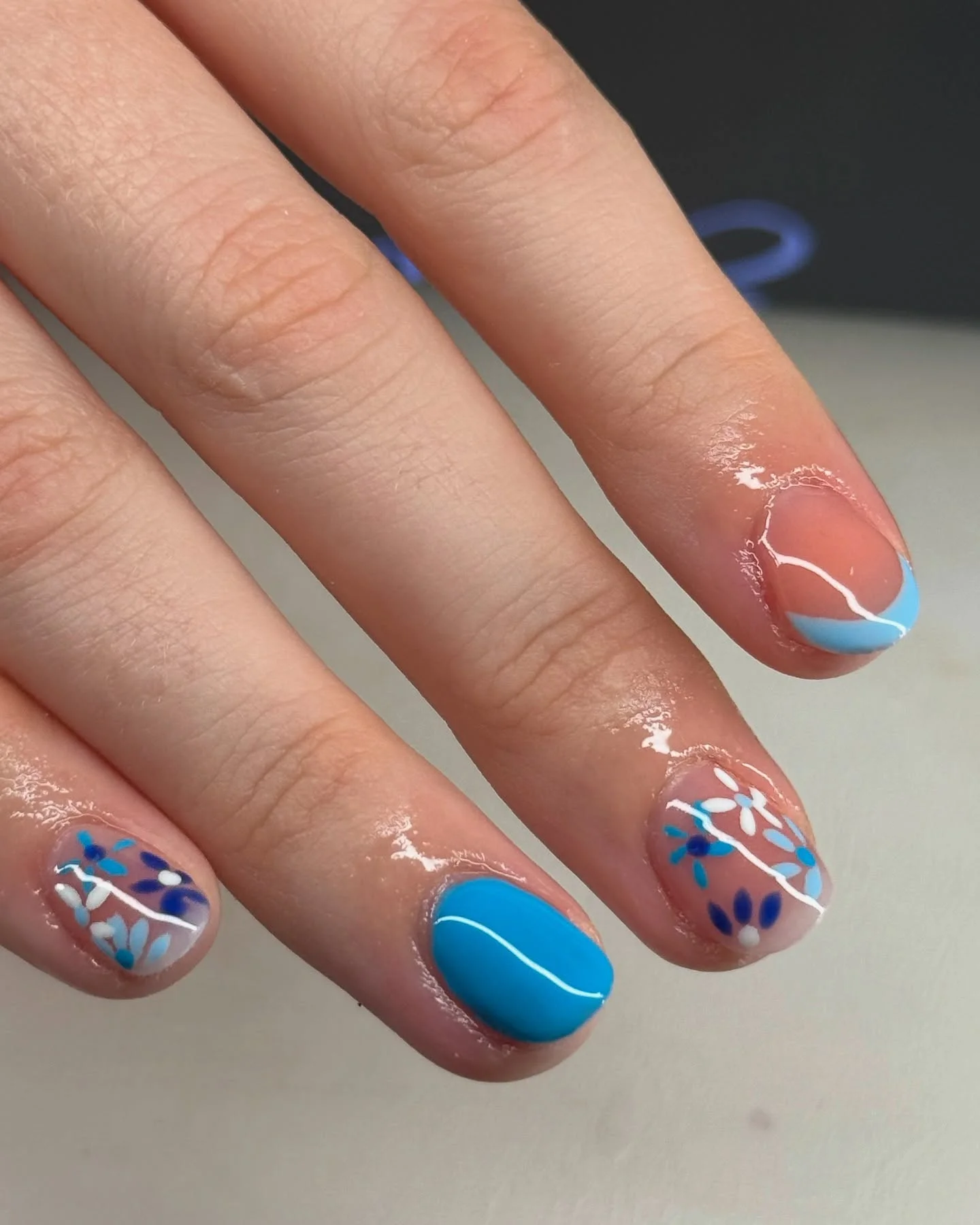 short summer nails 2026 Blue Floral Minimal Nails With Soft Graphic Lines