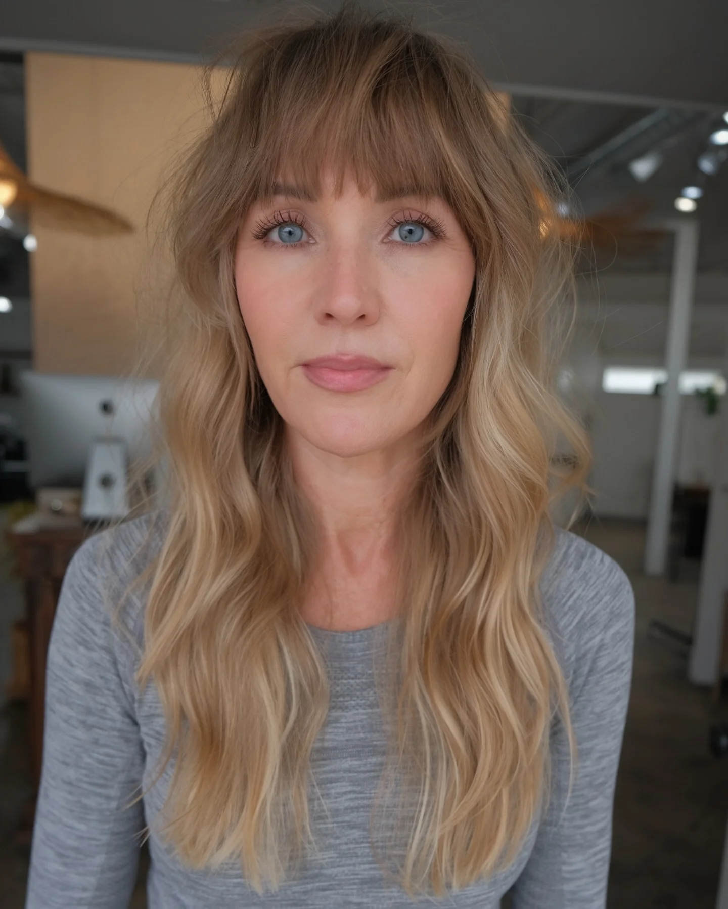 sophisticated summer haircuts for women over 40 2026 Soft Blonde Long Layers With Wispy Fringe