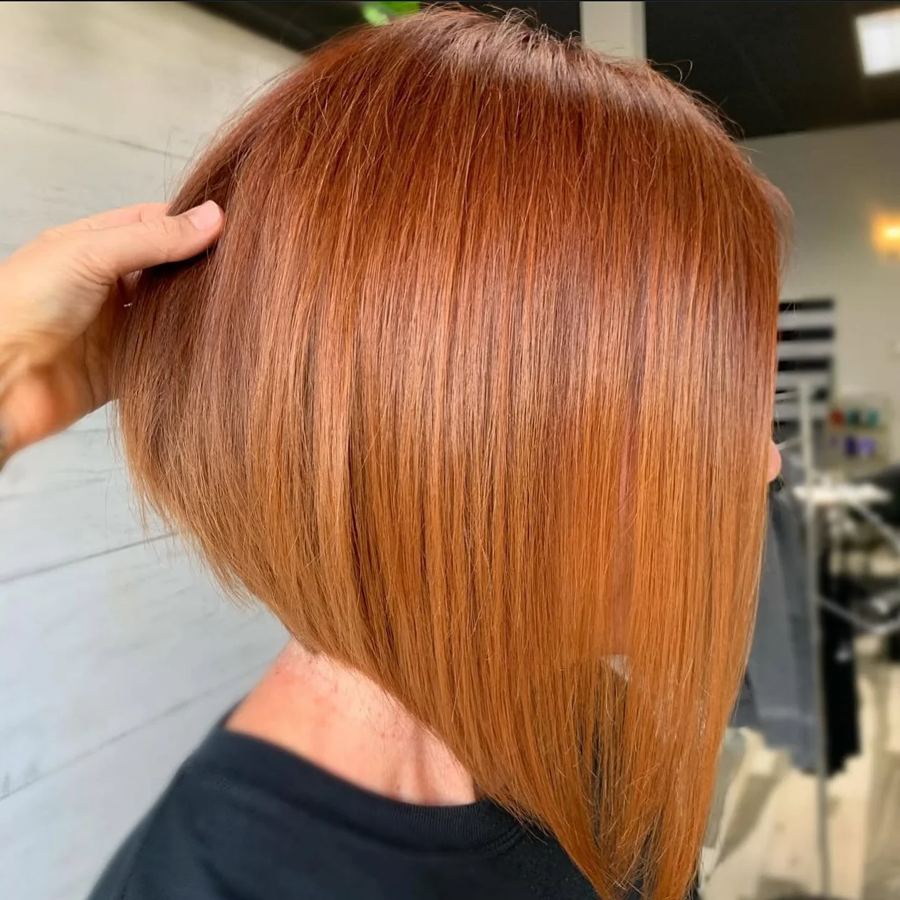 angled summer bob haircut 2026 Glossy Copper Precision Angle With Sleek Length