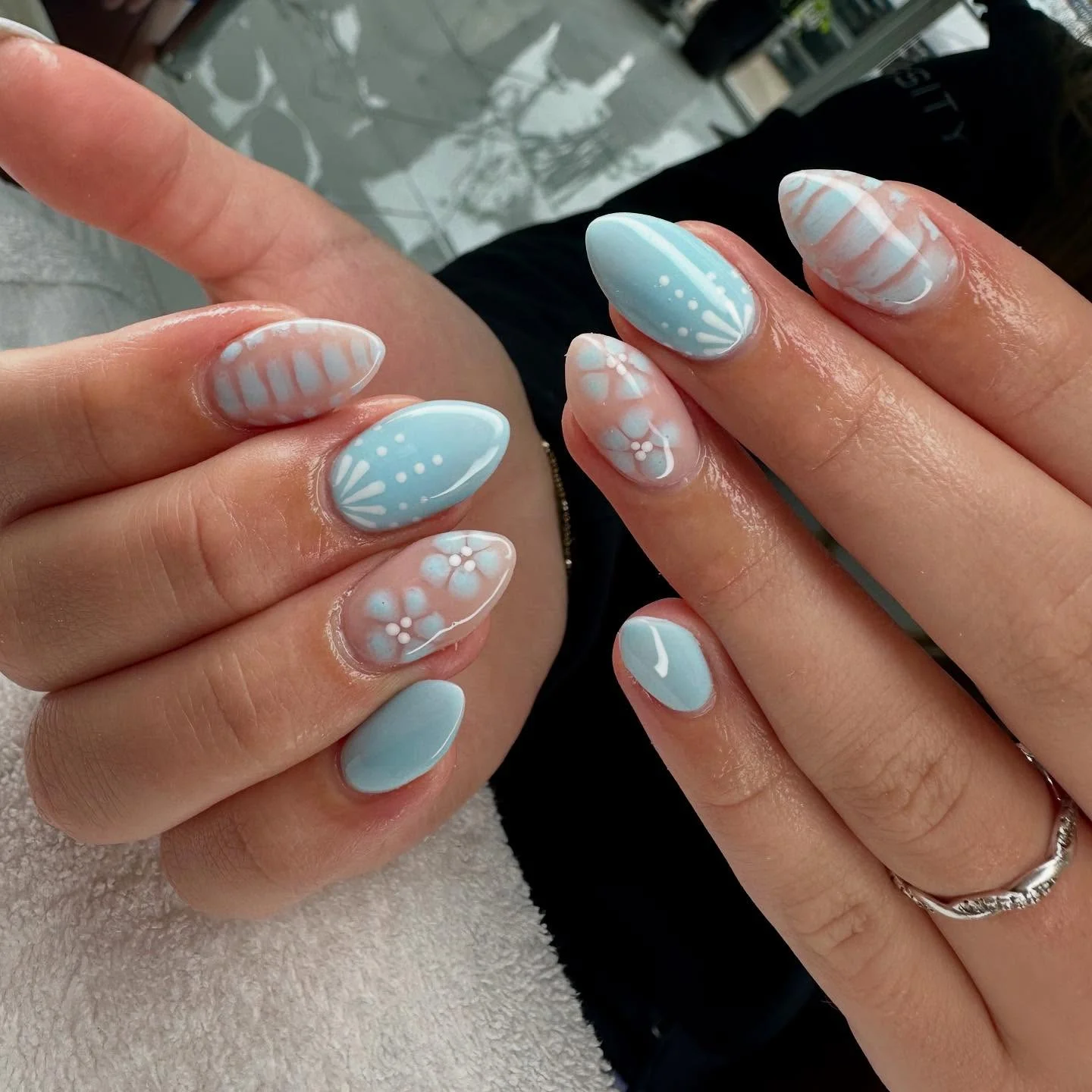 light blue summer nails 2026 Powder Blue Floral Almond Nails With Soft Cottagecore Details