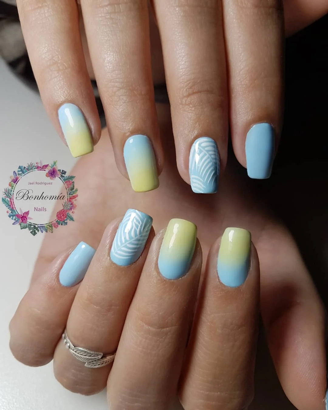 light blue summer nails 2026 Blue And Lemon Ombre Nails With Tropical Leaf Art