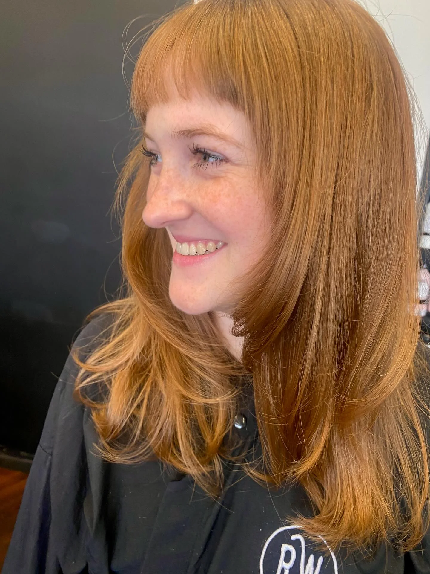 summer-haircuts-women-over-50 Glossy Copper Layers With Full Fringe
