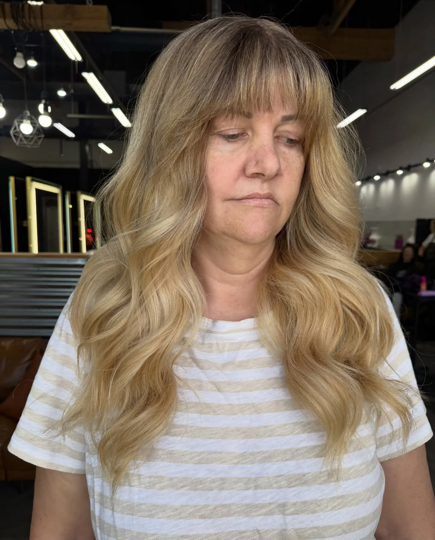 stylish summer haircuts for women over 60 2026 Long Layered Waves With Soft Curtain Bangs