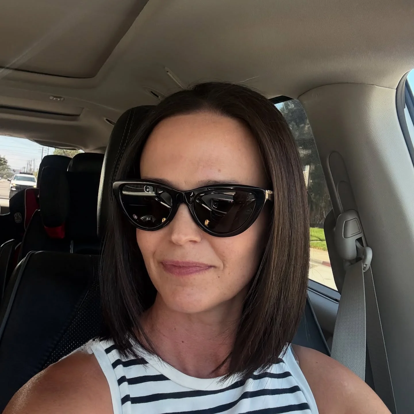 sophisticated summer haircuts for women over 40 2026 Sleek Straight Lob With Center Part And Sunglasses Styling