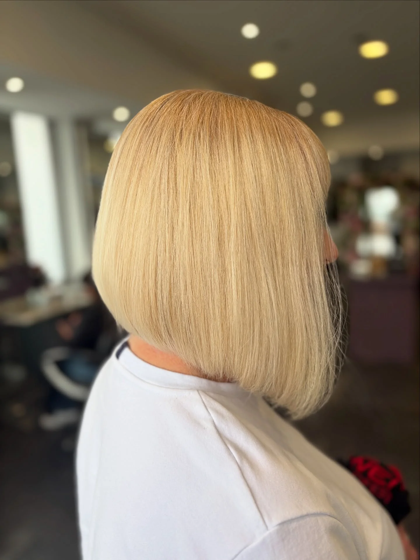 angled summer bob haircut 2026 Blunt Creamy Blonde Angle With Full Volume Finish