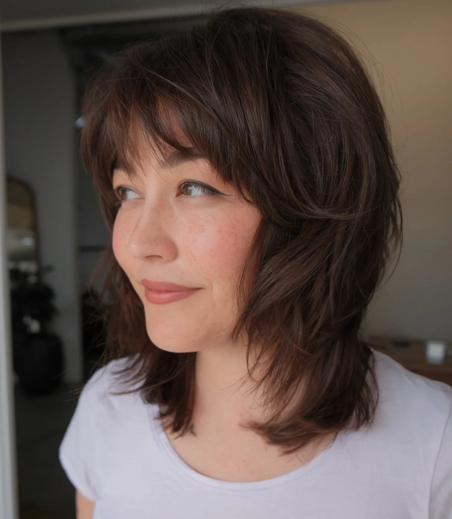sophisticated summer haircuts for women over 40 2026 Textured Medium Shag With Wispy Bangs