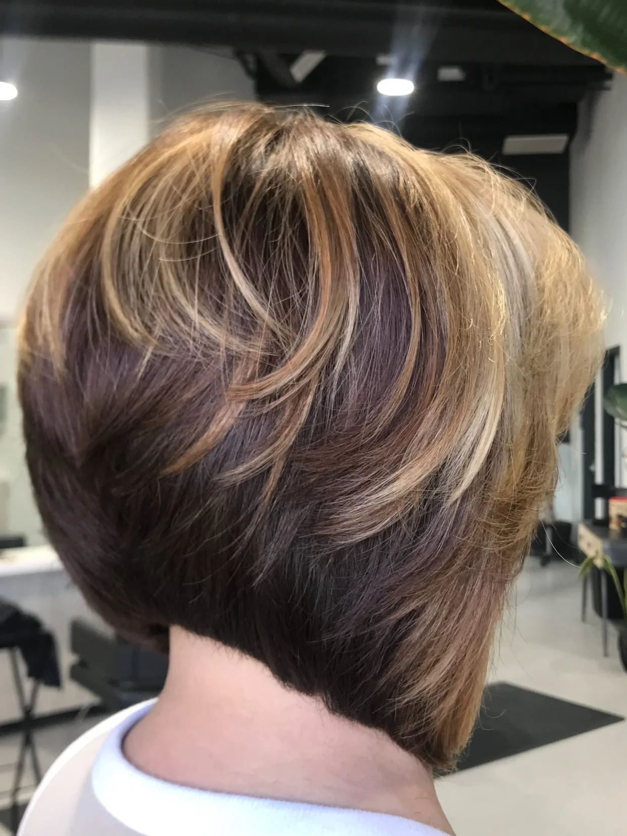 summer haircuts women over 50 Layered Brunette Bob With Dimensional Highlights
