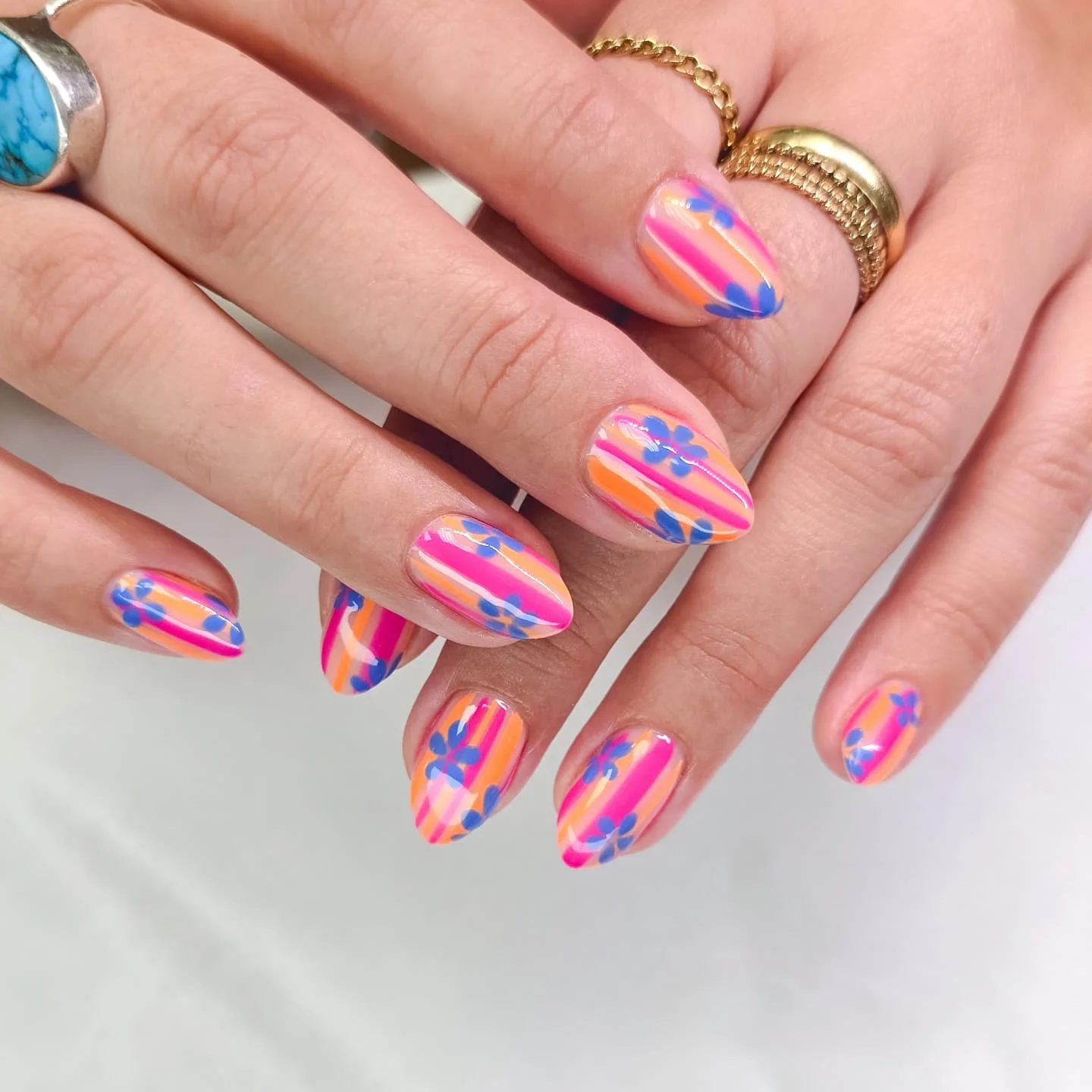 summer vibrant nails 2026 Sunset Stripe Nails With Playful Blue Florals