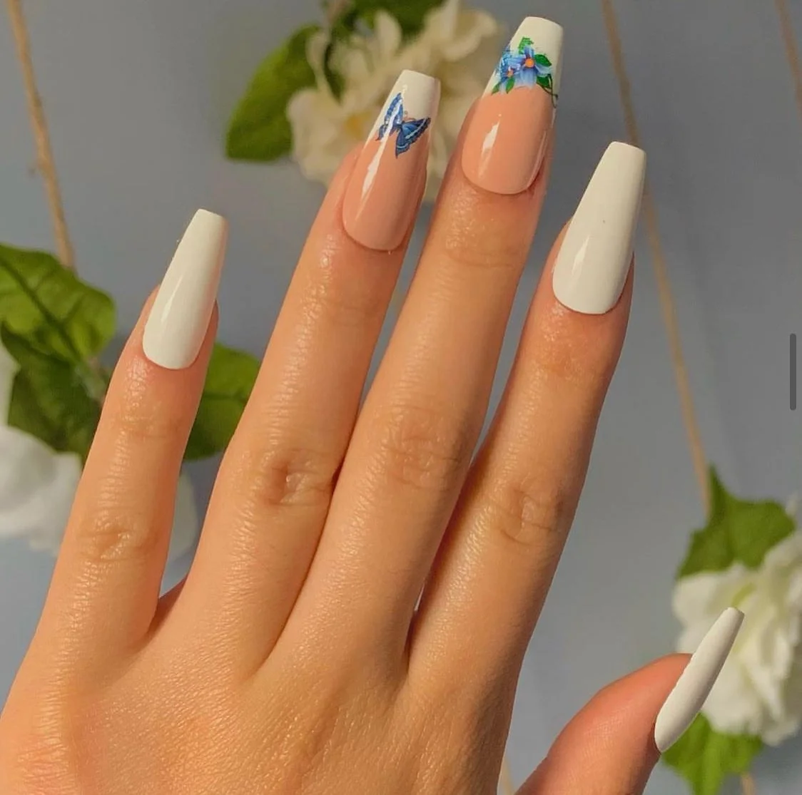 light summer nails 2026 Milky White Florals With Blue Butterfly Accents