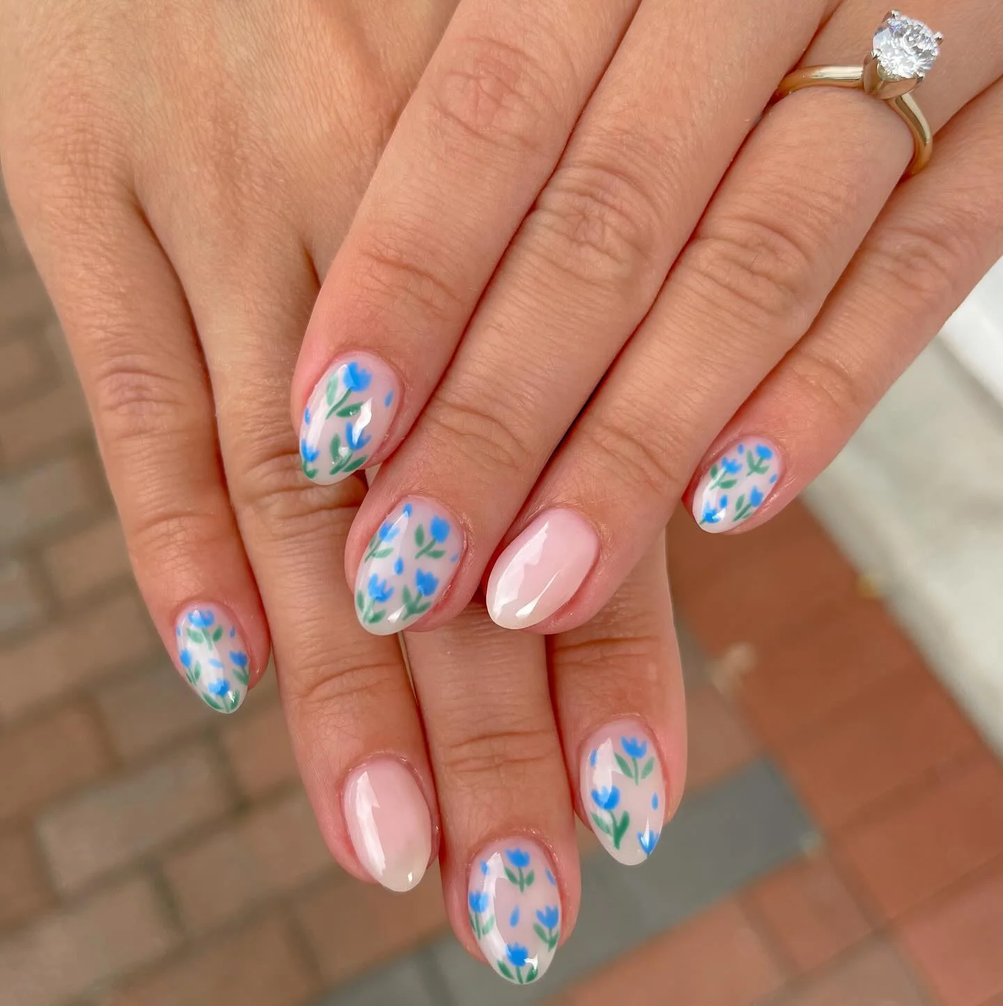 summer flower nails 2026 Soft Blue Botanical Nails With A Glossy Almond Finish