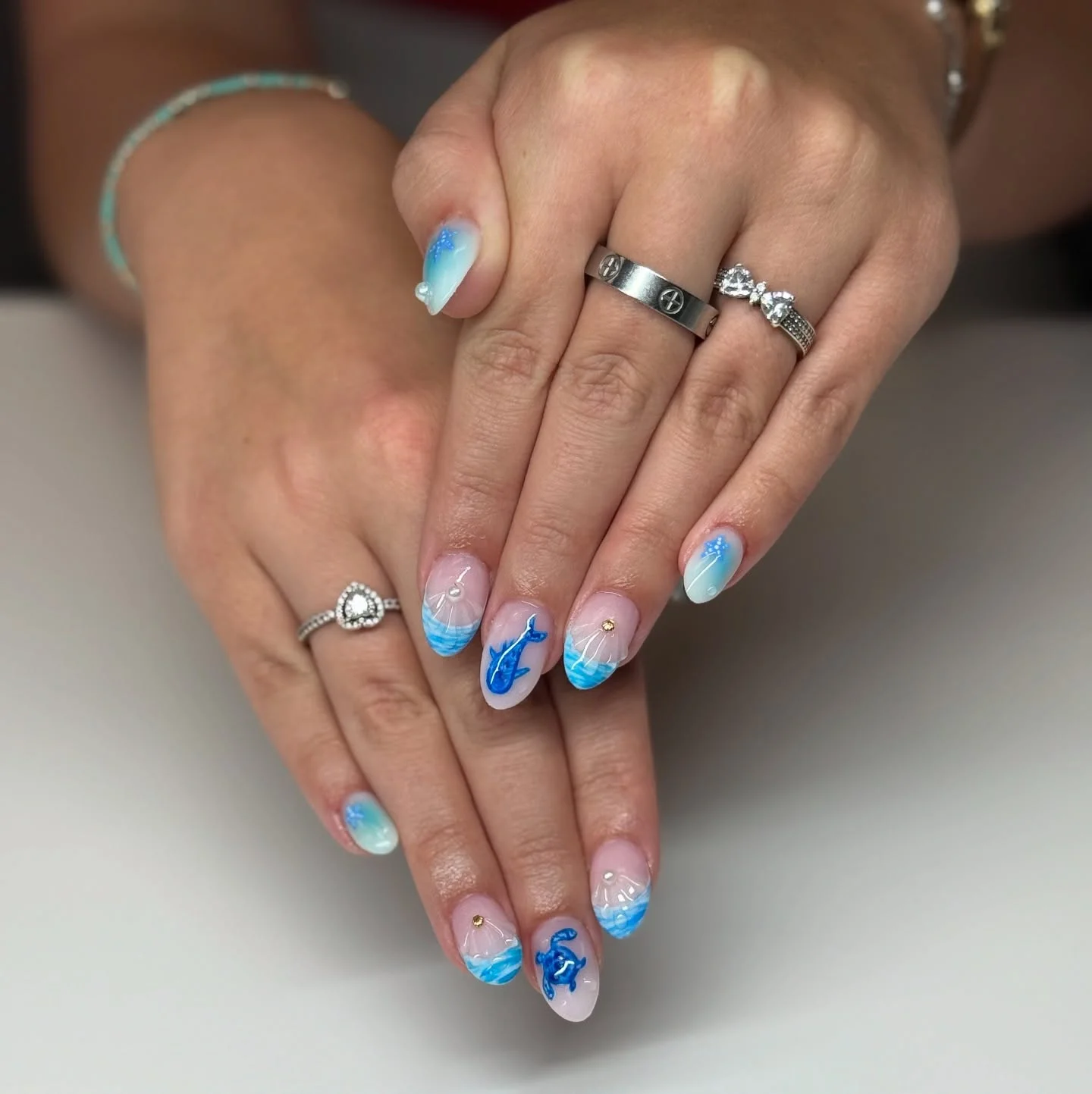 trendy summer nails 2026 Ocean Glass Almond Nails With Coastal Blue Details
