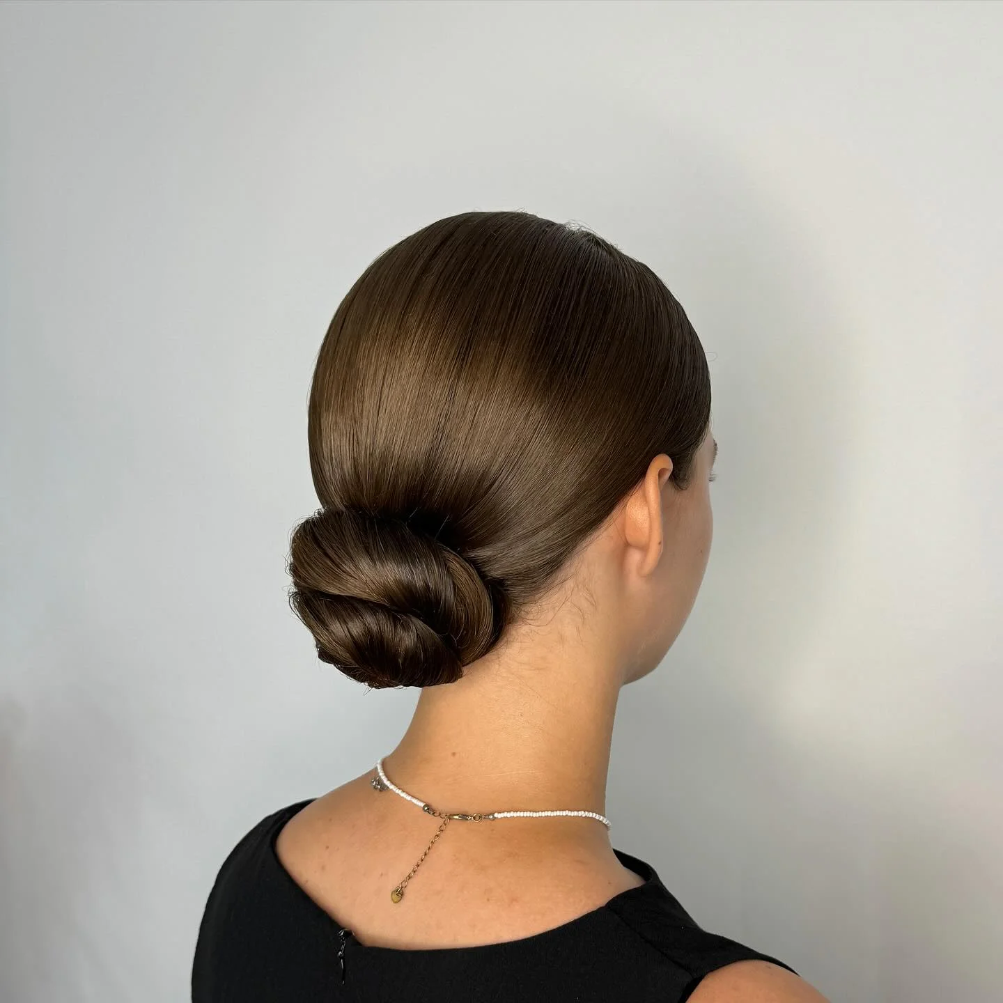 flattering summer quick hairstyles 2026 Low Sleek Buns Are Quiet Luxury For Hot Weather