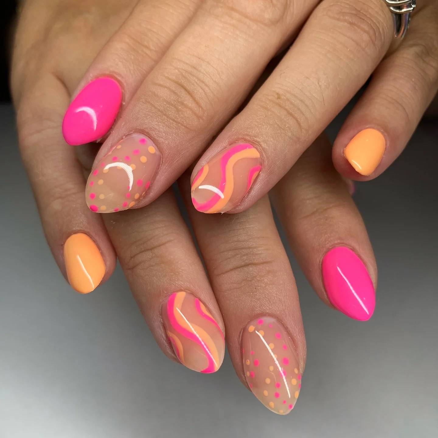 june manicure ideas 2026 Neon Pink And Peach Retro Swirl Designs