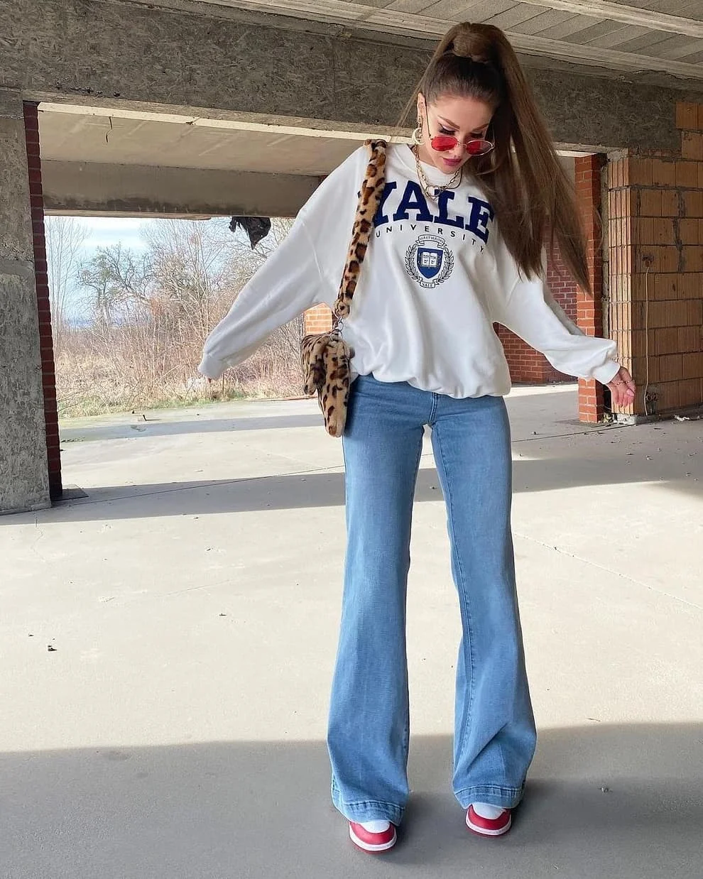 fall outfits for college students casual 2026 Oversized College Sweatshirt With Flared Denim Revival