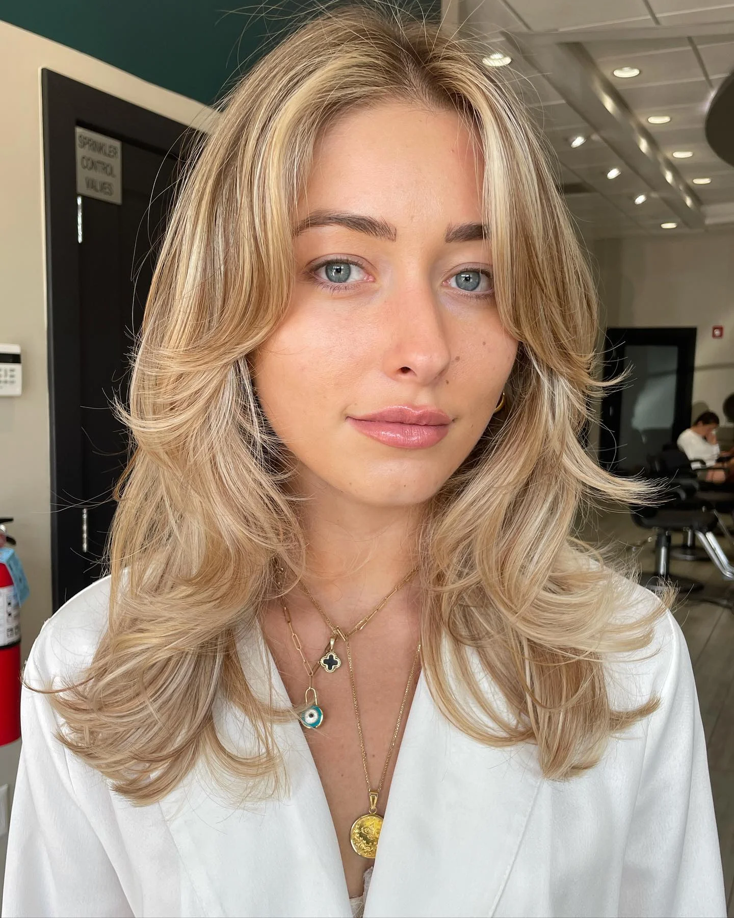 july hair color ideas Buttercream Blonde Layers With Face-Framing Softness