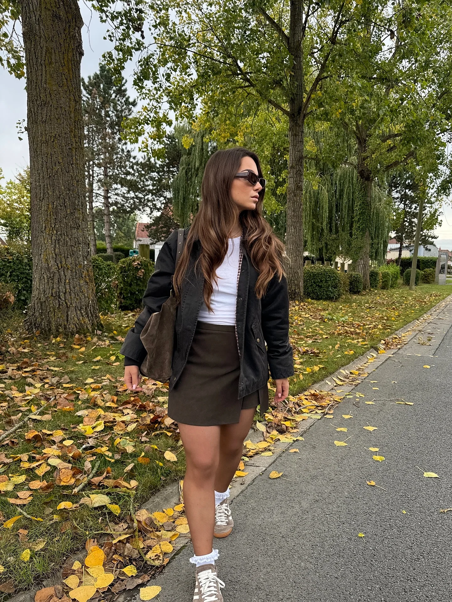 fall outfits ideas 2026 Leather Mini Skirt And Sneakers For Casual Weekend Energy
