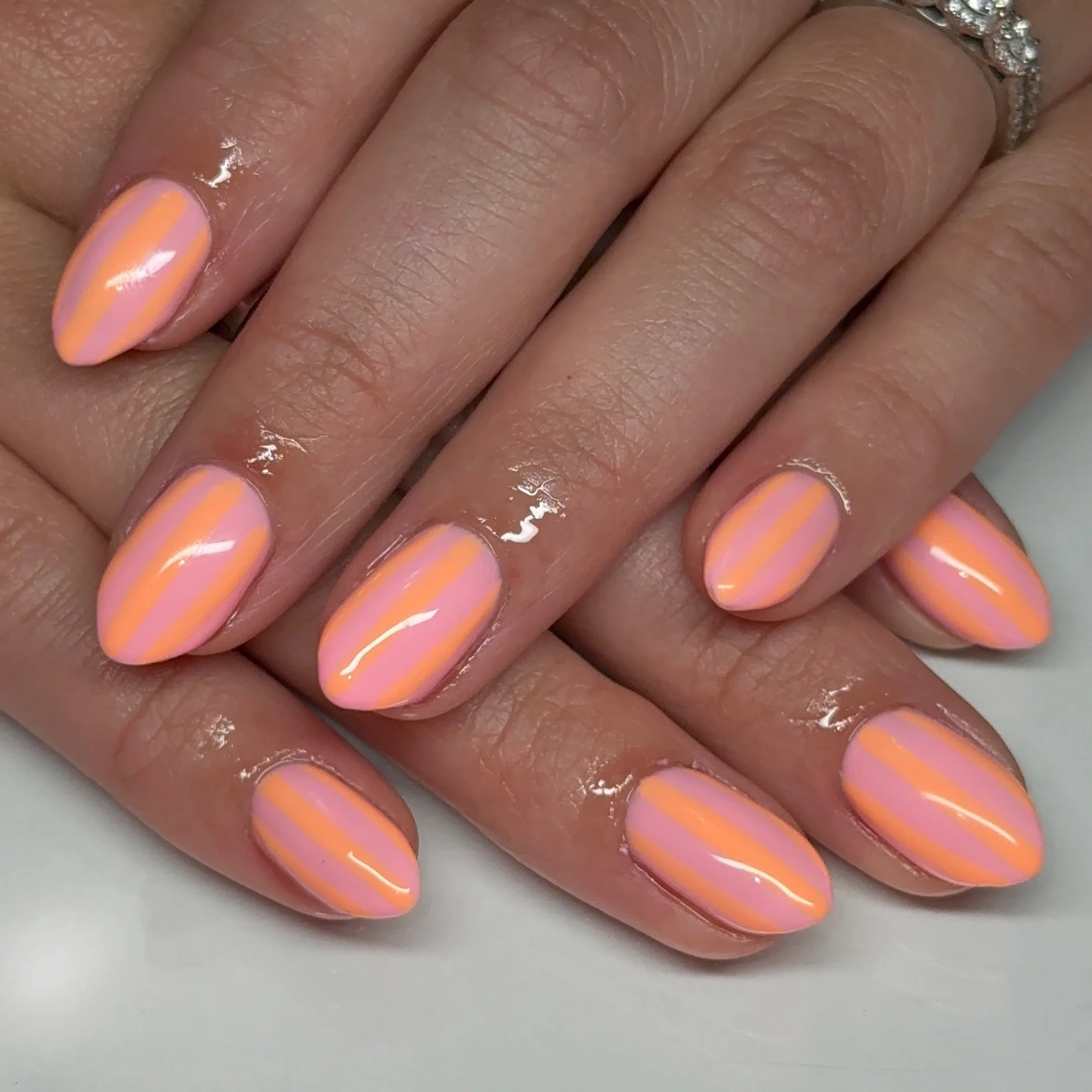 june manicure ideas 2026 Peach And Pink Stripes For A Modern Minimalist Look