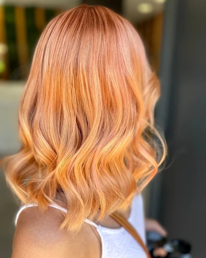 july hair color ideas Peach Rose Gold Bob With Summer Glow